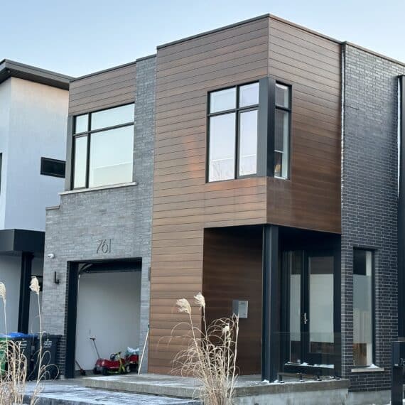 A modern style home with wood siding and concrete floors.